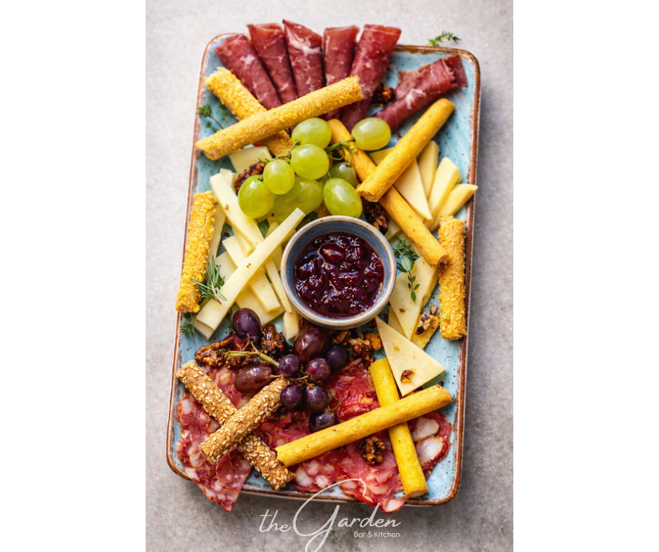 Gourmet charcuterie and cheese board with grapes, breadsticks, and home made sweet peppers chutney at The Garden Bar & Kitchen, Kardamena, Kos.