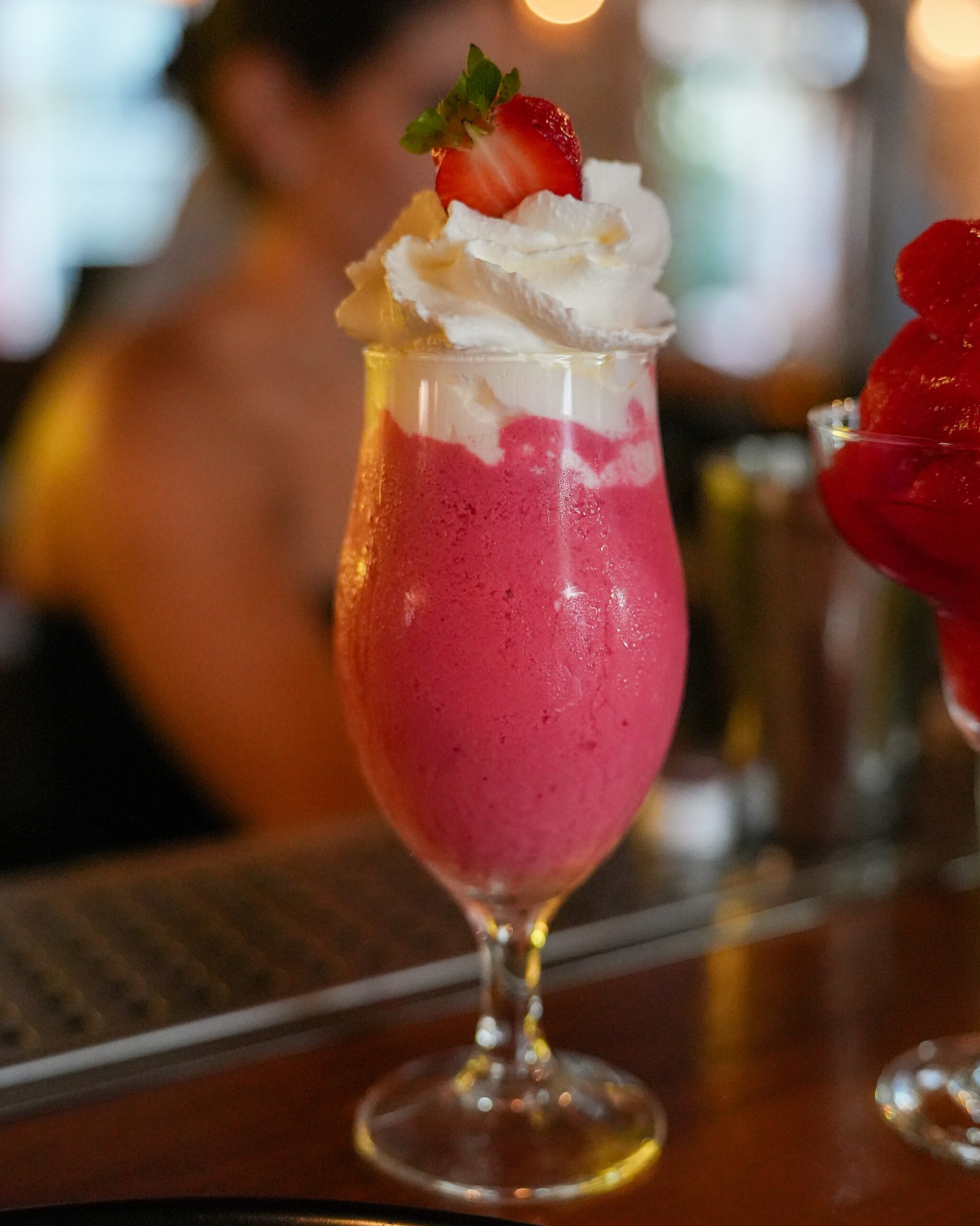 Strawberry Short Cake cocktail with whipped cream and fresh strawberry garnish at The Garden Bar & Kitchen, Kardamena, Kos